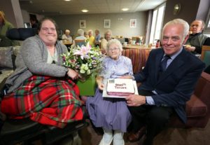 Claire Rabbetts and Bill Midgley celebrate with our 500th tenant, Joan Toward